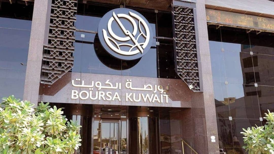 Traders monitoring share prices on the Kuwait Stock Exchange.