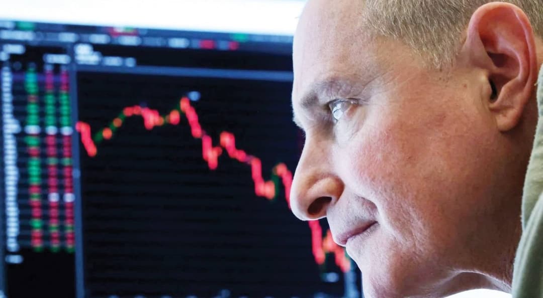A trading screen displaying red figures across major global stock market indices during a turbulent week of selling pressure.