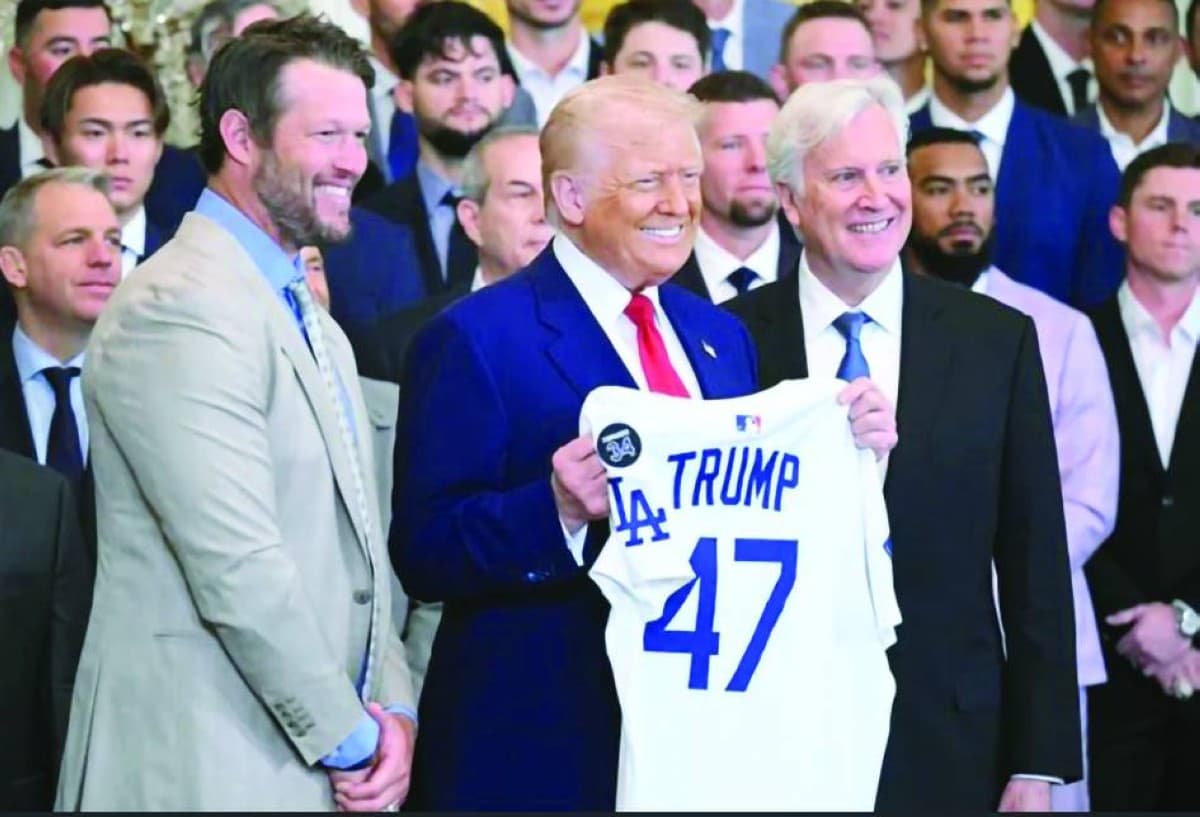 Donald Trump holds up a Los Angeles Dodgers jersey alongside pitcher Clayton Kershaw and team owner Mark Walter at a White House ceremony honouring the 2024 World Series champions.