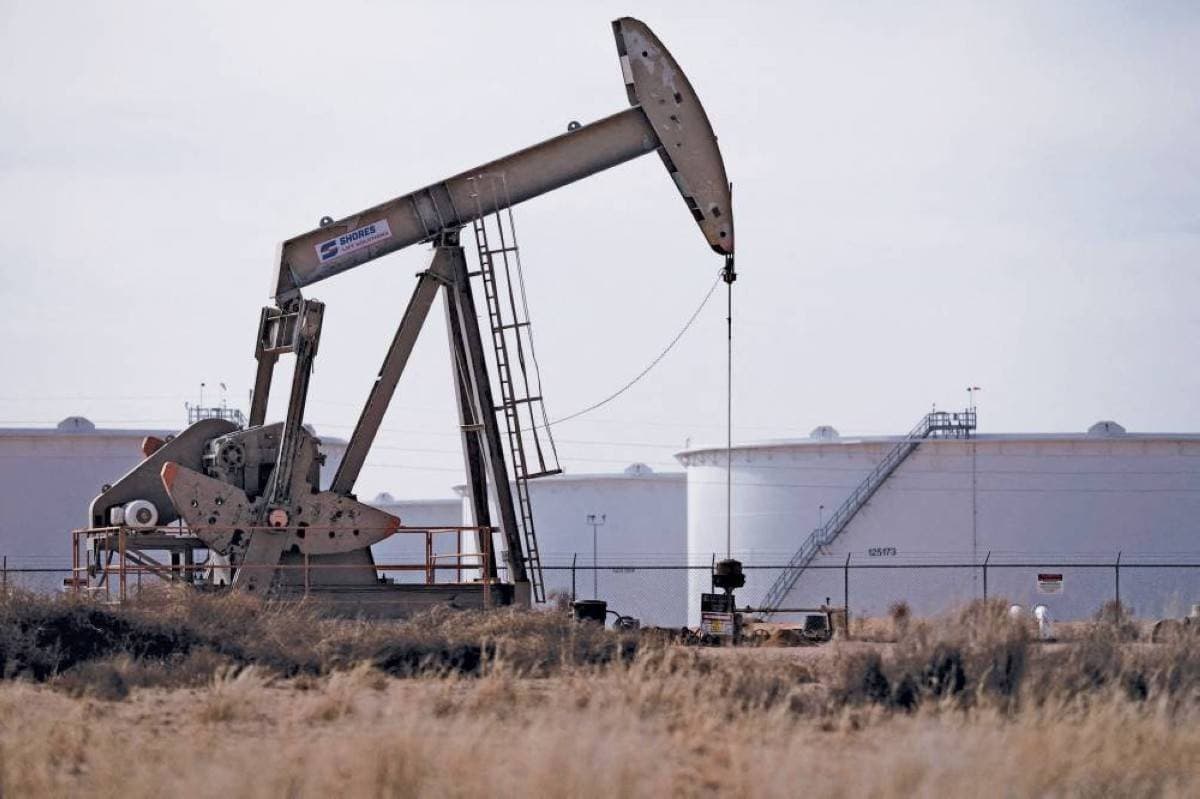 Oil price ticker board showing declining crude prices amid Middle East geopolitical tensions.