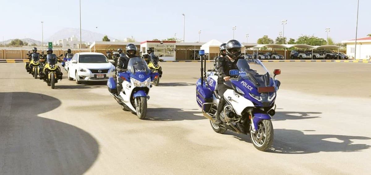 Abu Dhabi Police officers pose with graduates of the foundational motorcycle training course at the Criminal Justice Institute in Al Ain.