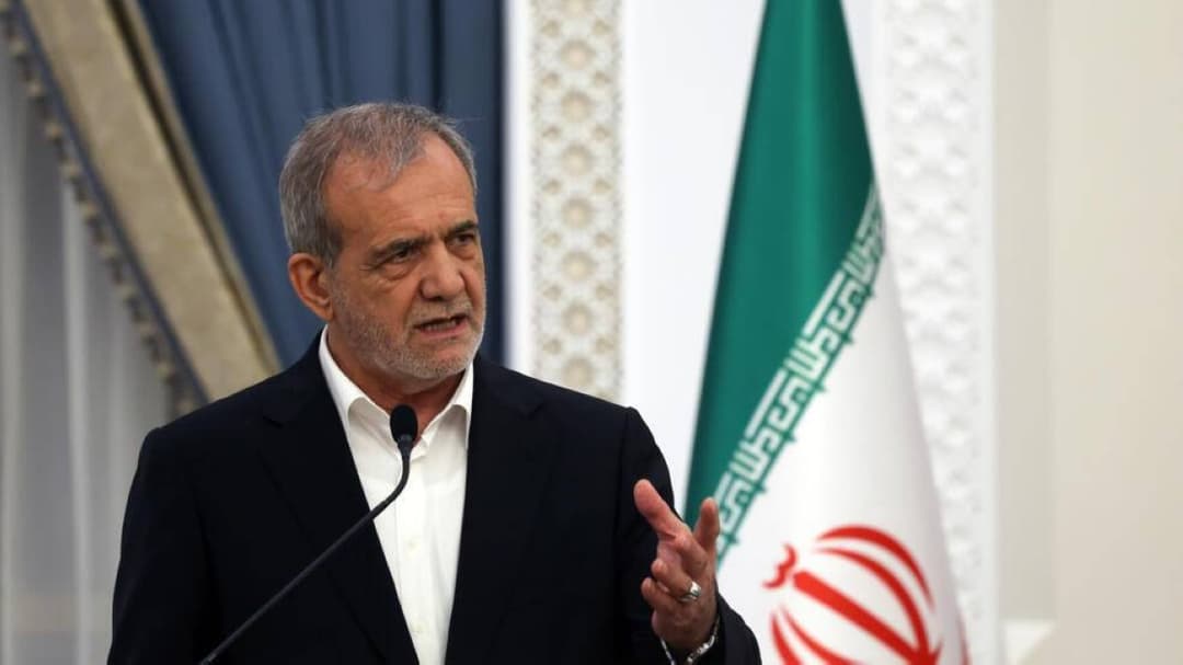 Iranian President Masoud Pezeshkian speaking at an official government setting.