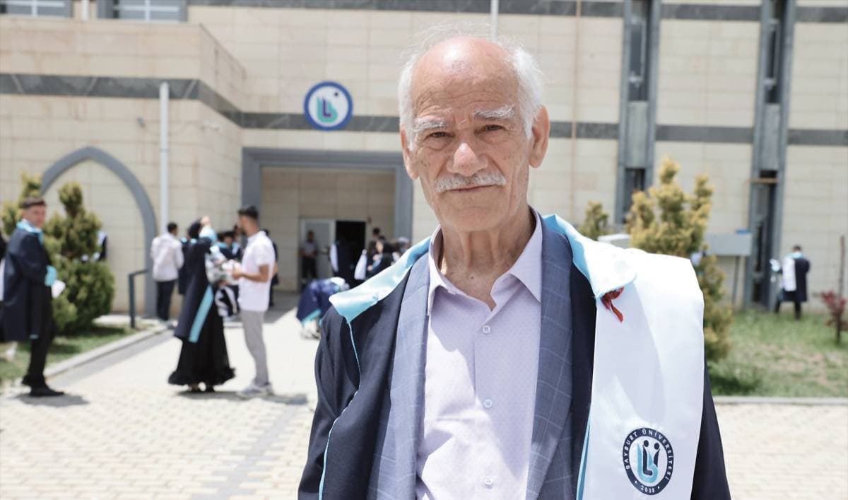 A 75-year-old Turkish man, Vasil Ceydar, stands among fellow graduates at his graduation ceremony at Bayburt University in Turkey.