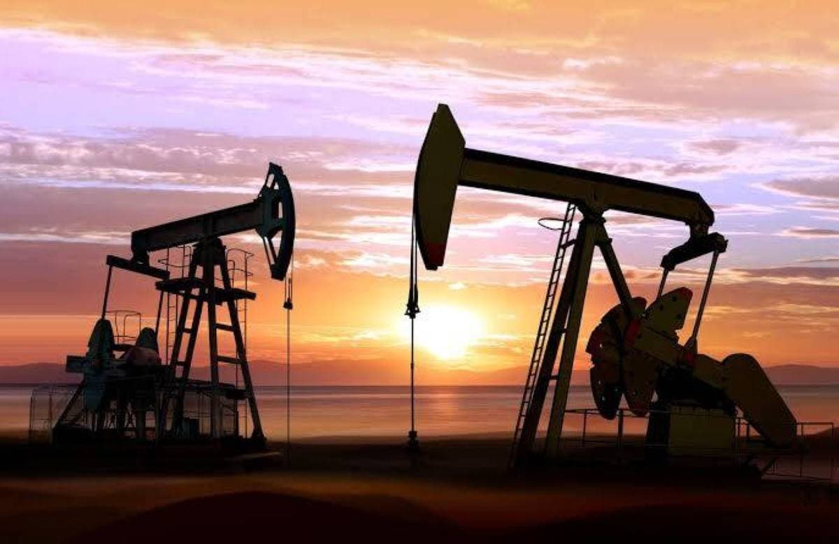 Oil storage tanks and infrastructure representing falling crude prices amid a US-Iran ceasefire deal.
