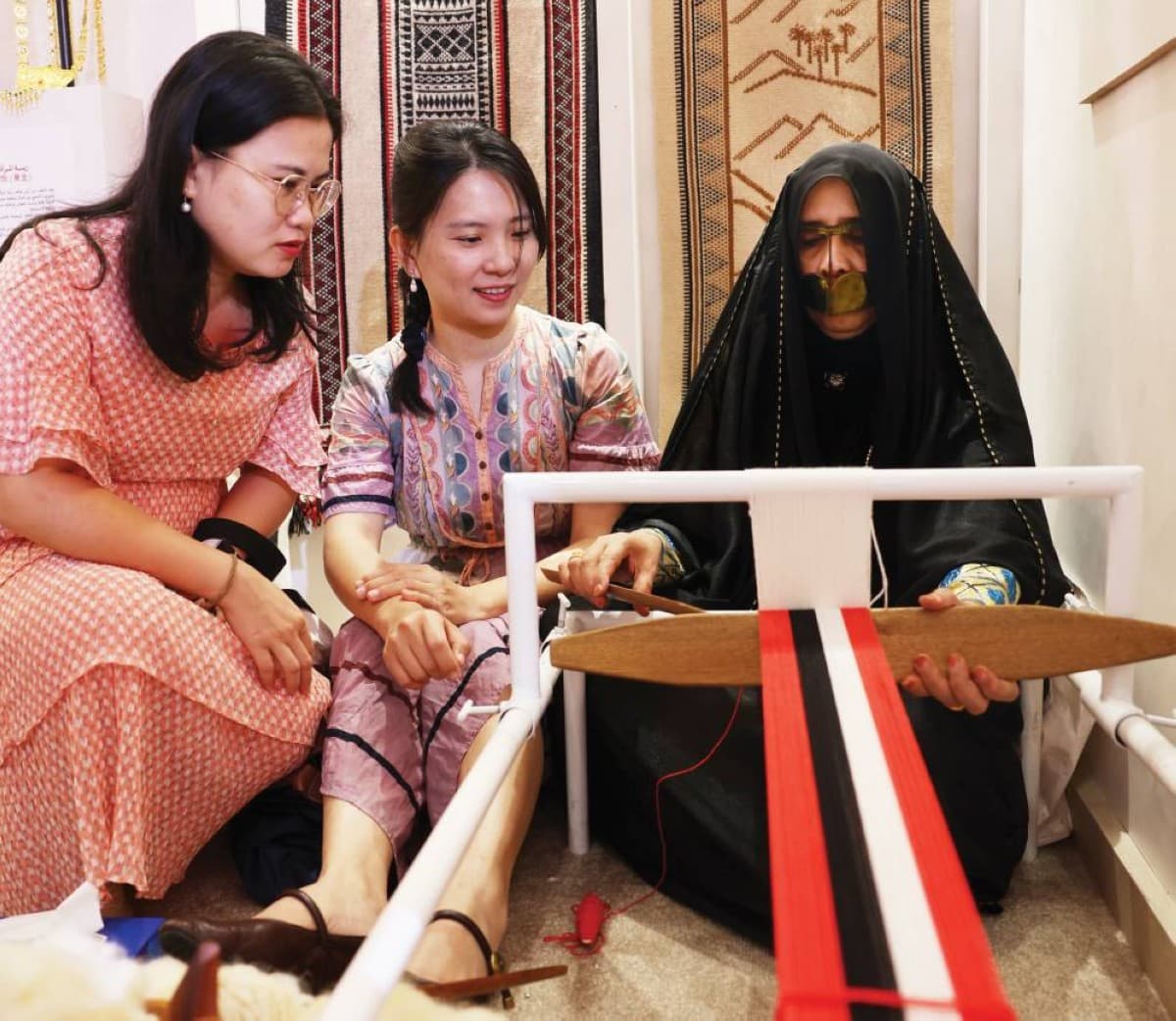 Emirati craftswomen display traditional Sadu weaving and heritage perfumes at the UAE pavilion during the 2026 Beijing International Book Fair.