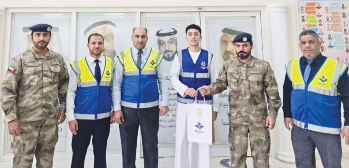 Abu Dhabi Police officials honouring student volunteers Fahad Mahmoud Al Hamadi and Mohammed Mustafa Hamdan from Al Falah School at a ceremony recognising their achievement in the Arab Reading Challenge.