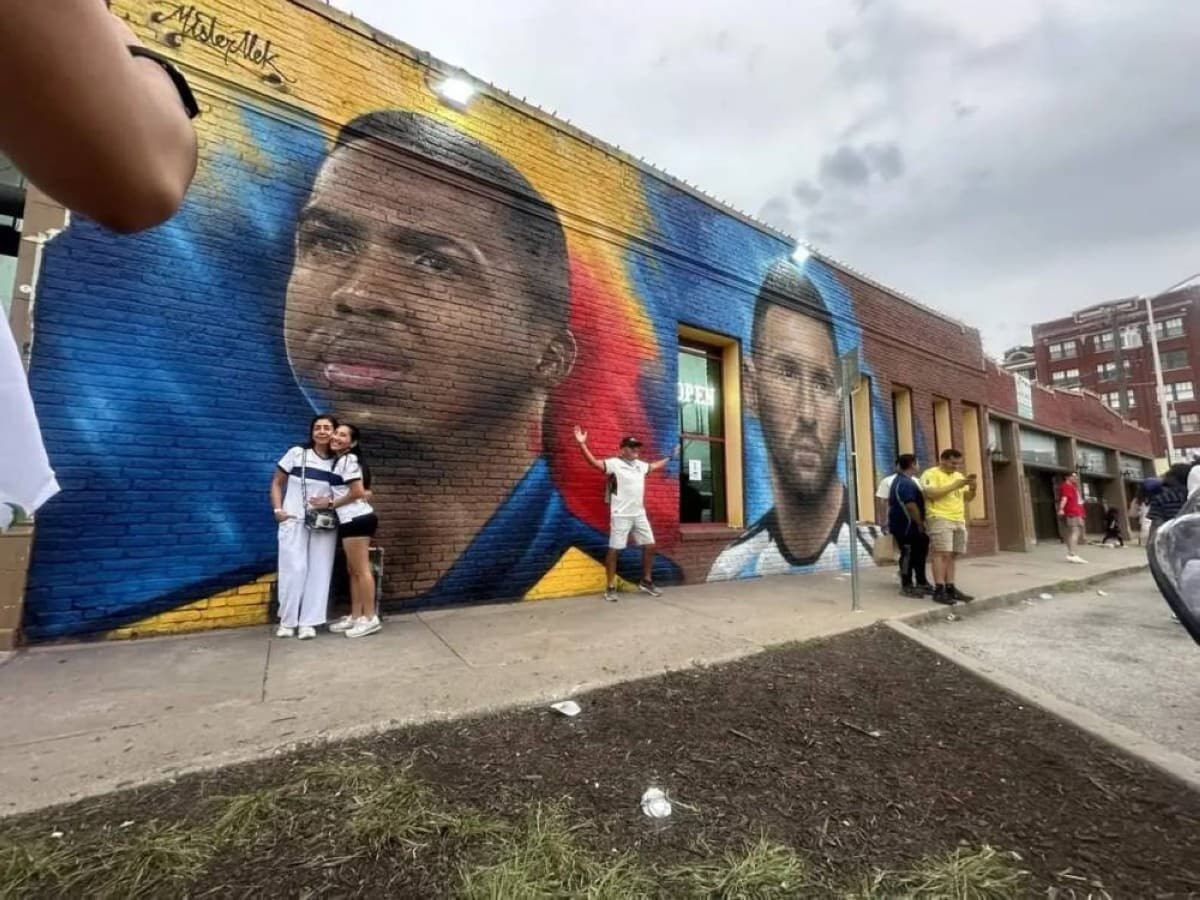 A large mural on the wall of an Ecuadorian restaurant in Kansas City depicting Ecuador and Paris Saint-Germain defender Willian Pacho alongside Argentina legend Lionel Messi.