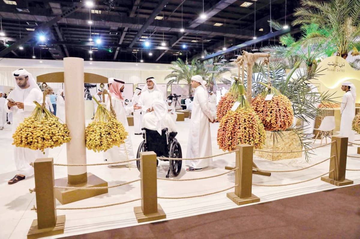 Visitors and participants at the Dubai Dates Festival competing in a palm tree exhibition at Qasr Al Rimal on the Dubai–Al Ain Road.