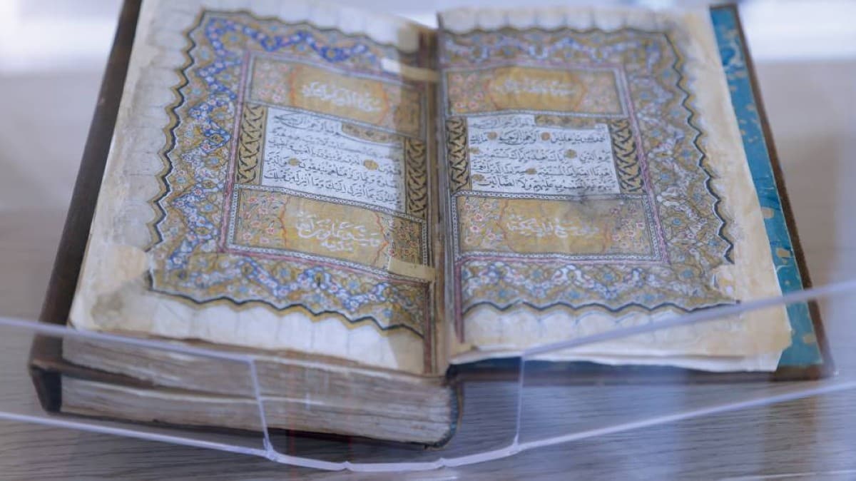 A visitor examines rare historical Arabic manuscripts on display at the 'Manuscripts: Identity and Sustainable Development' exhibition held at UAE University in cooperation with Bait Al Hikma.