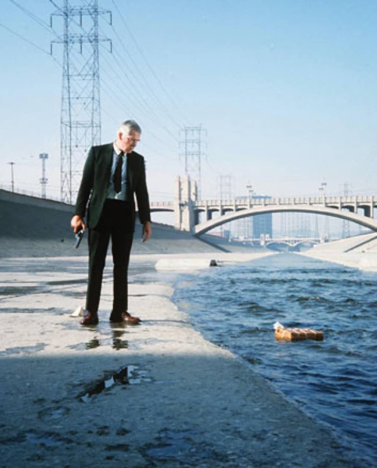 A promotional still from the 1967 film Point Blank, depicting Lee Marvin as the steely, trench-coated Walker navigating the shadowy urban landscape of Los Angeles.