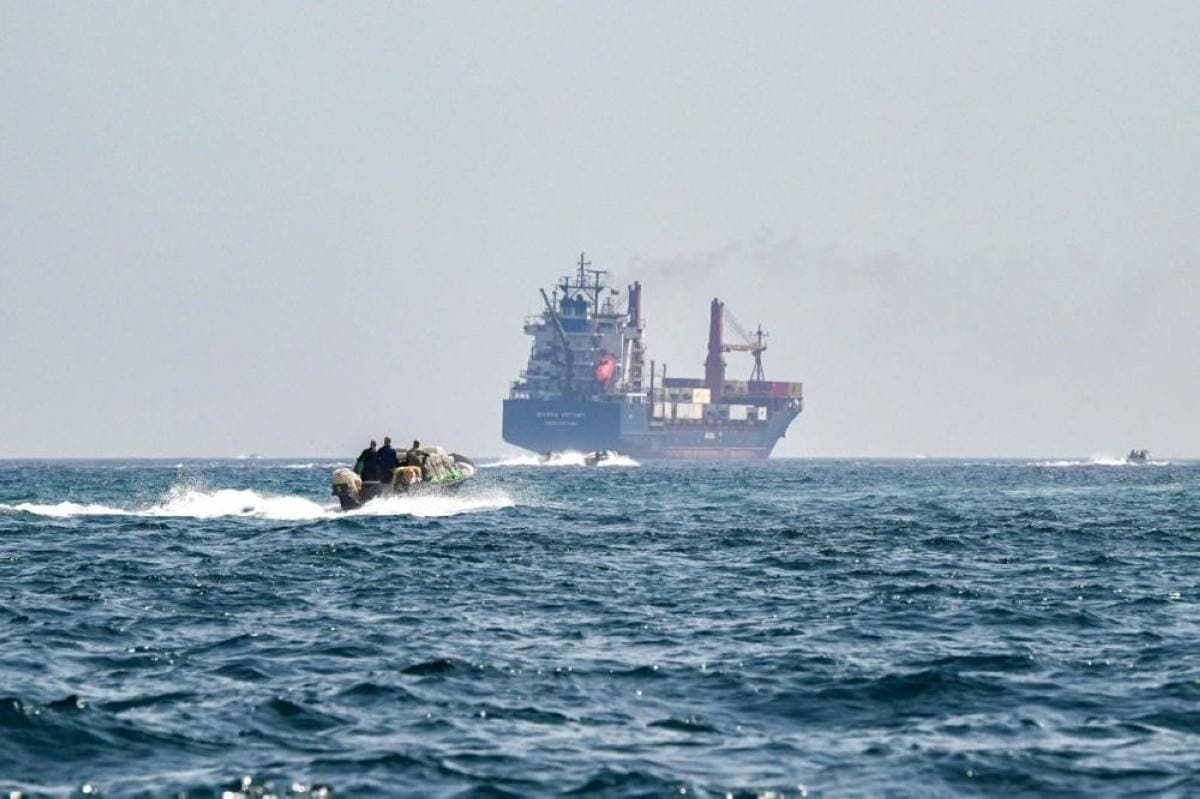 A maritime vessel navigating through the Strait of Hormuz, a strategically vital waterway between Oman and Iran.