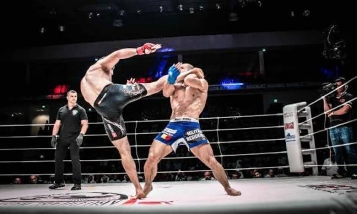 Fighters competing at a UAE Warriors MMA event held at an arena in Abu Dhabi.