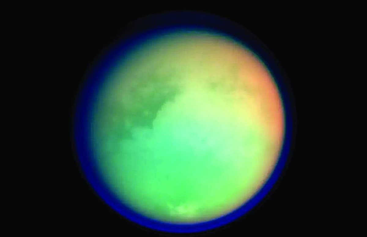 An illustration or image of Titan, Saturn's largest moon, with its hazy atmosphere and surface features visible.