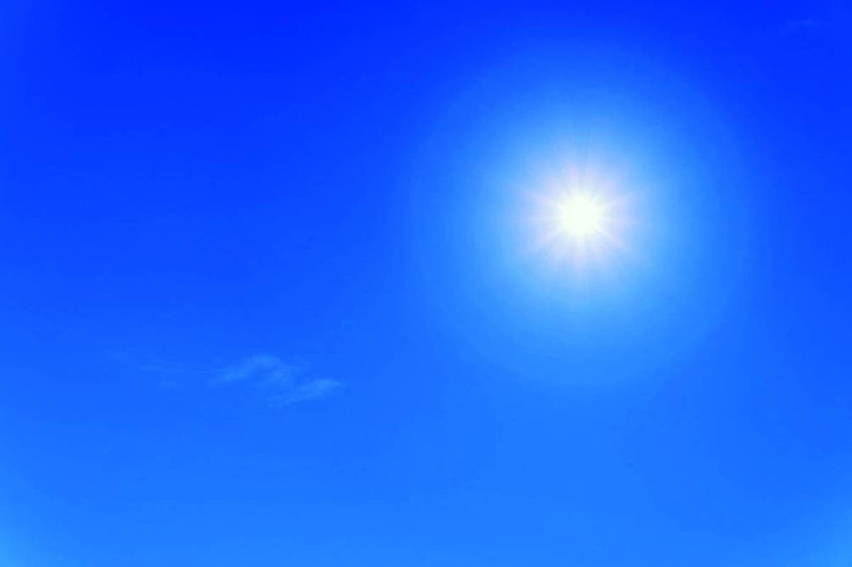 A person walking outdoors in natural daylight, illustrating the link between sun exposure and reduced dementia risk.