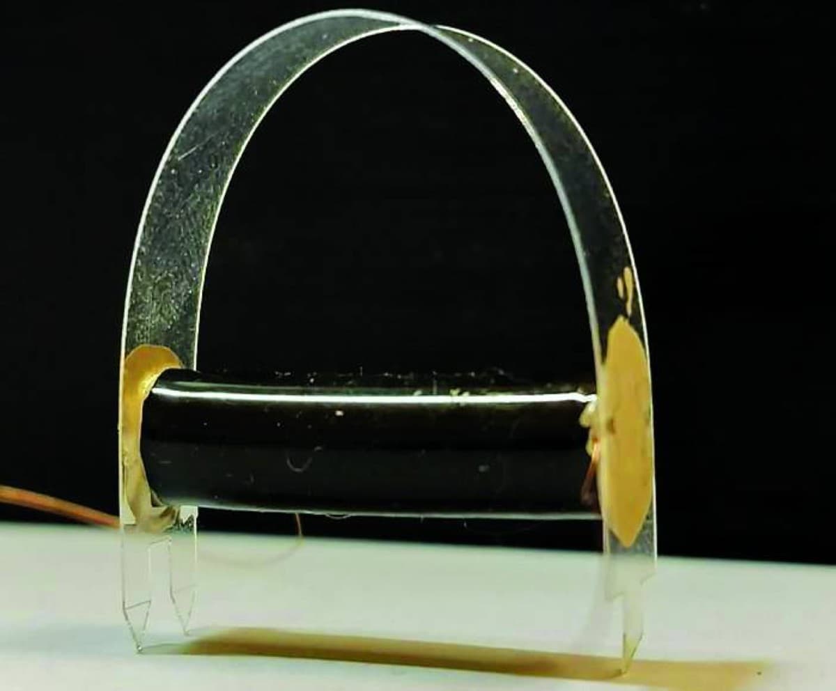 A microscopic flexible robot composed of alternating polymer and carbon electrode layers, approximately the thickness of a human hair.