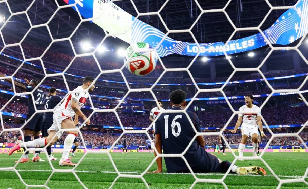 A scene from the United States versus Turkey World Cup group stage match, with players contesting the ball on the pitch.