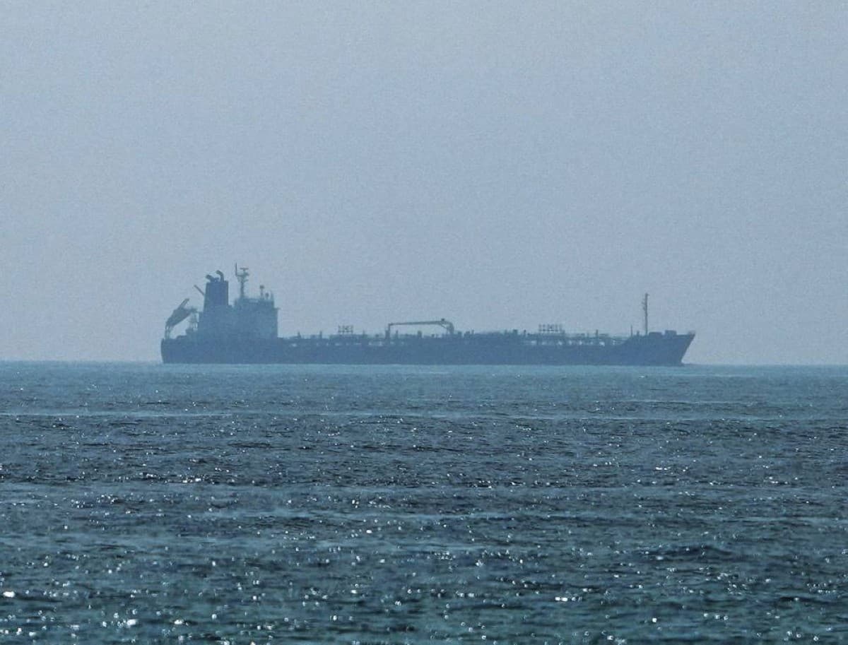 A cargo vessel transits the Strait of Hormuz amid heightened security tensions following drone attacks attributed to Iran.
