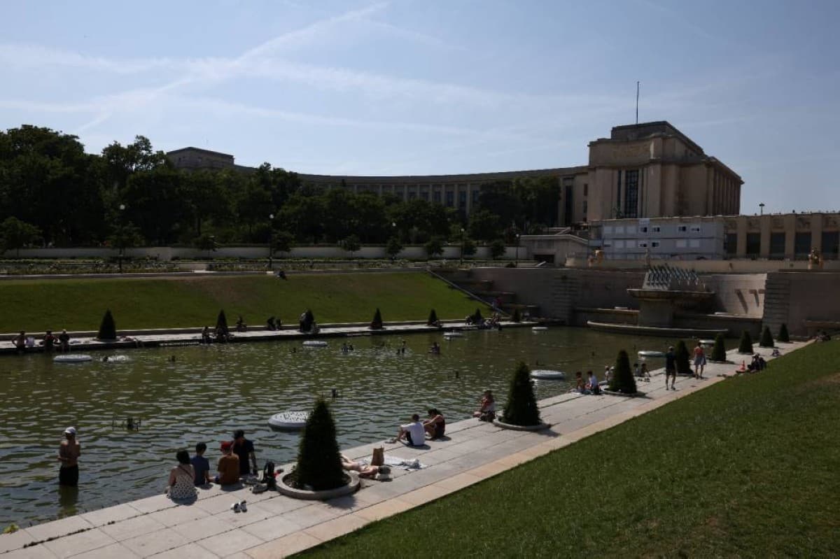 People cooling off in a body of water in France during an intense summer heatwave.
