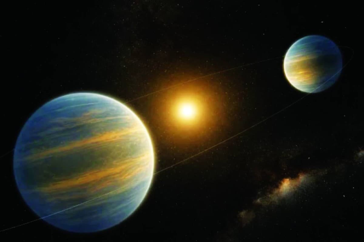 An artist's illustration of two giant low-density exoplanets orbiting a distant star approximately 1,100 light-years from Earth.