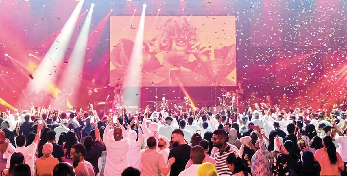 A concert stage bathed in colourful lights at a live music event in Dubai.