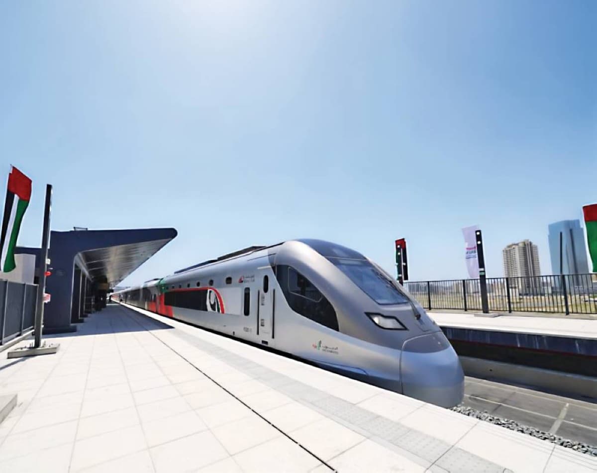 A passenger train on the Etihad Rail network preparing to depart from a UAE station.