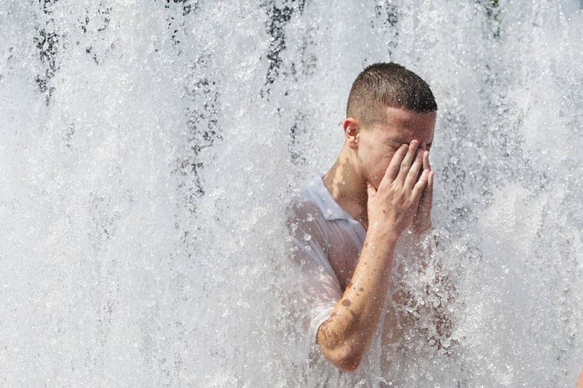 Emergency services personnel and members of the public seek relief from the intense heatwave gripping central Europe, as France begins tallying heat-related deaths.