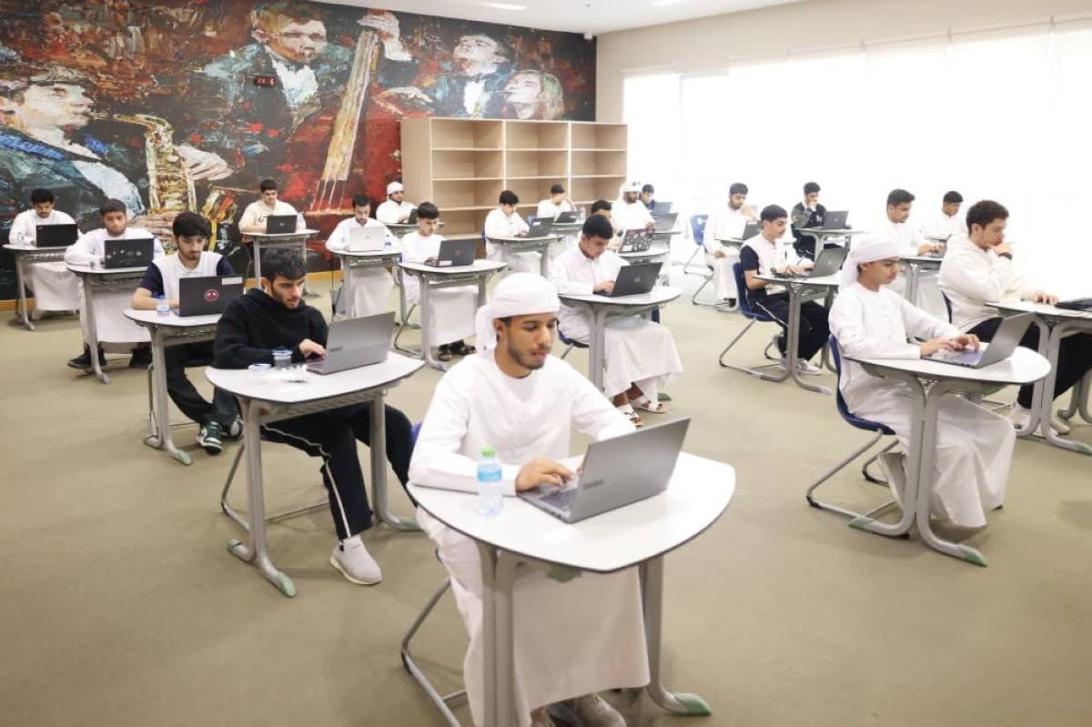 Grade 12 students walking out of a physics exam at a UAE school after completing their test.