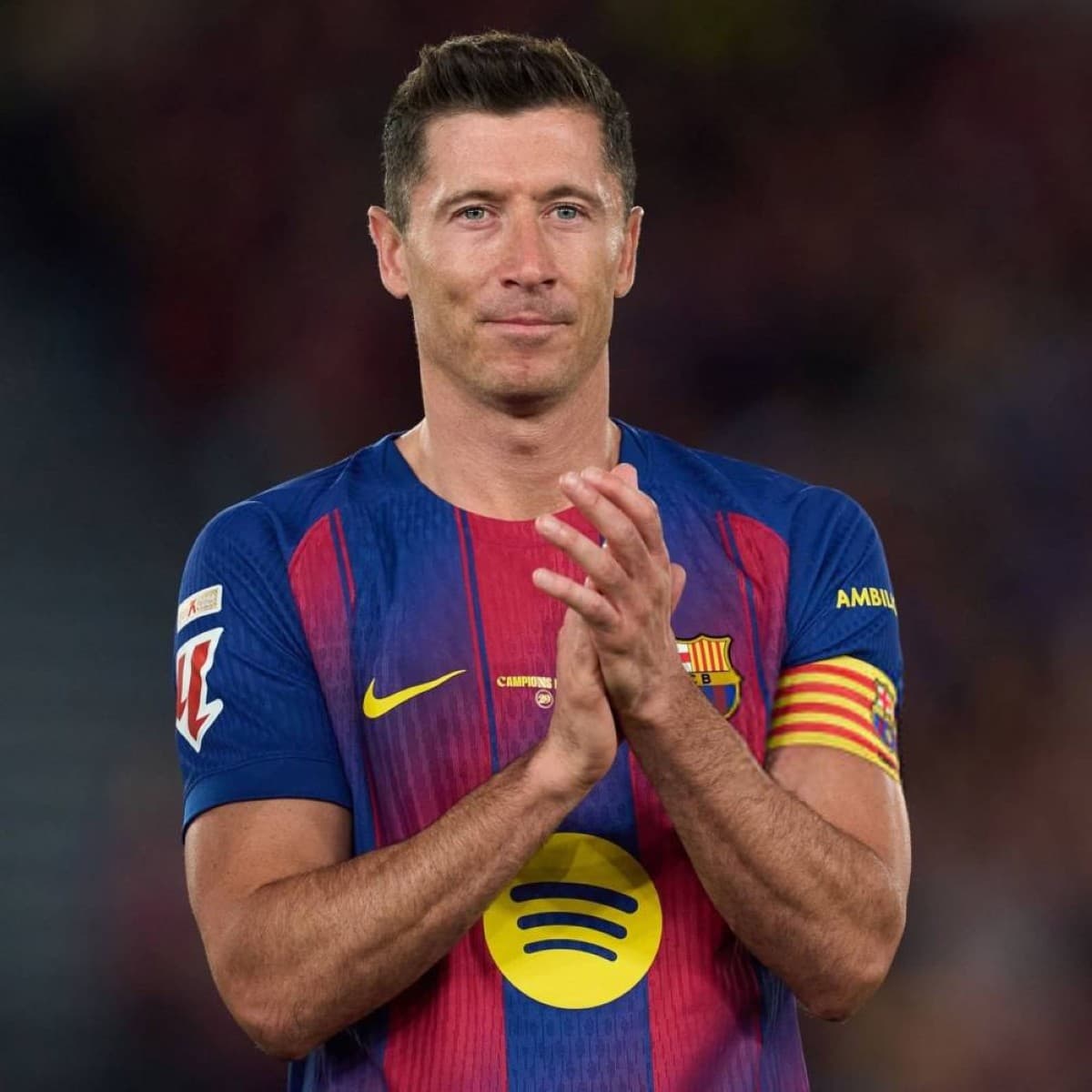 Robert Lewandowski poses in a Chicago Fire jersey after officially signing a two-year contract with the Major League Soccer club.