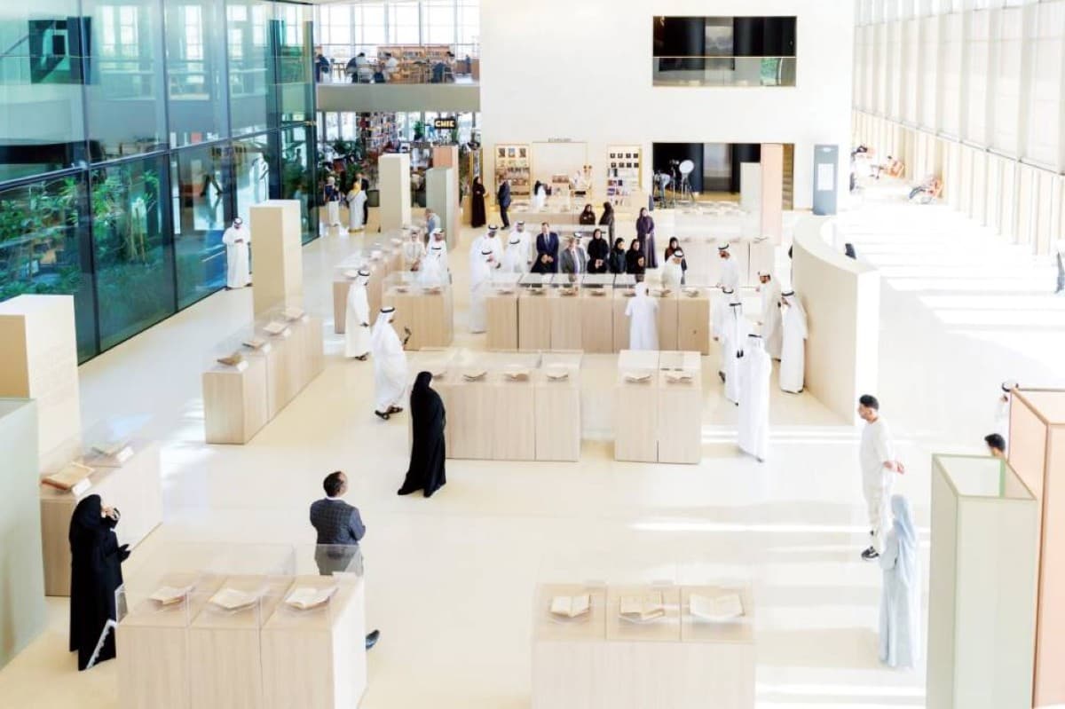 Visitors browsing rare manuscript displays at the 'Manuscripts: Identity and Development' exhibition held at Bait Al Hikma in Sharjah.