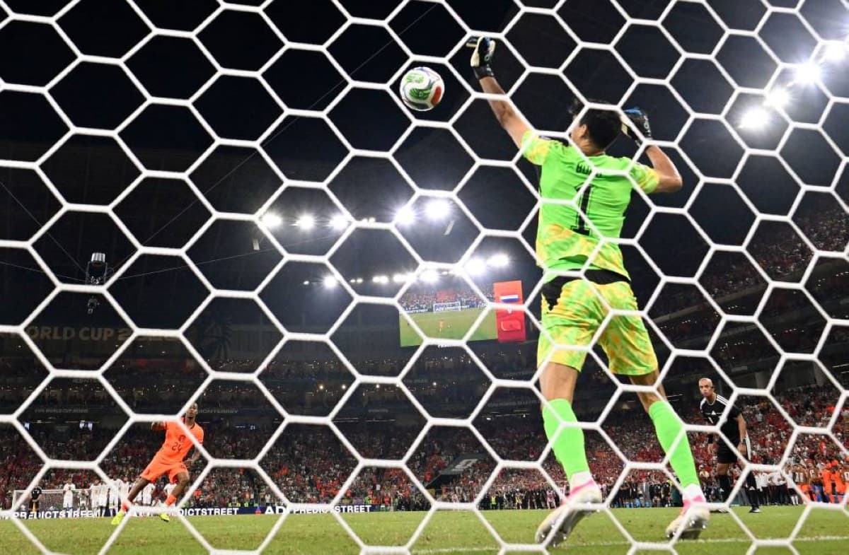 Moroccan goalkeeper Yassine Bono stands his ground to make a penalty save during a 2026 FIFA World Cup match.