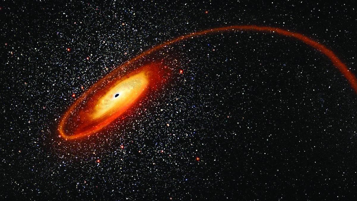 An artistic rendering of a black hole tearing apart a white dwarf star at the edge of a distant galaxy.