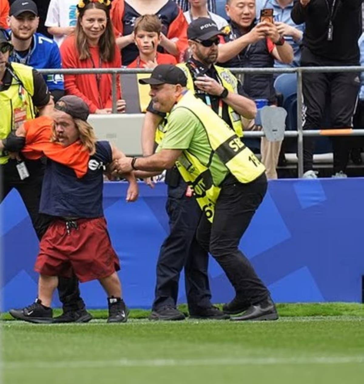 American influencer Joshua Kravchenko being escorted out of the stadium by security personnel after attempting to invade the pitch during the Belgium vs Senegal World Cup match in Seattle.