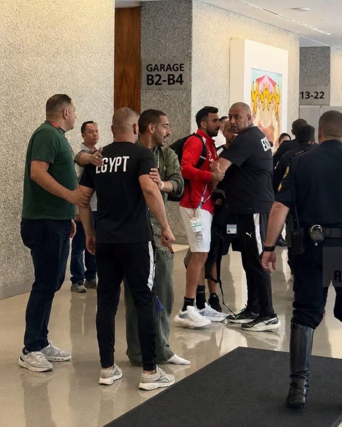 Egypt national team manager Ibrahim Hassan intervening during a confrontation with security personnel at the team's hotel base.