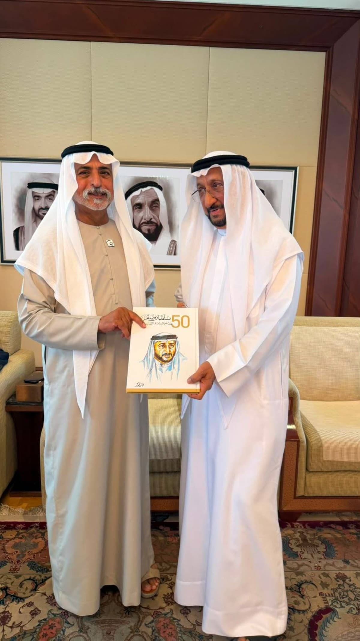 Sheikh Nahyan bin Mubarak Al Nahyan receives a copy of the book 'Sultan Saqr... 50 Years with Emirati Sport' during a meeting at his palace in Abu Dhabi.