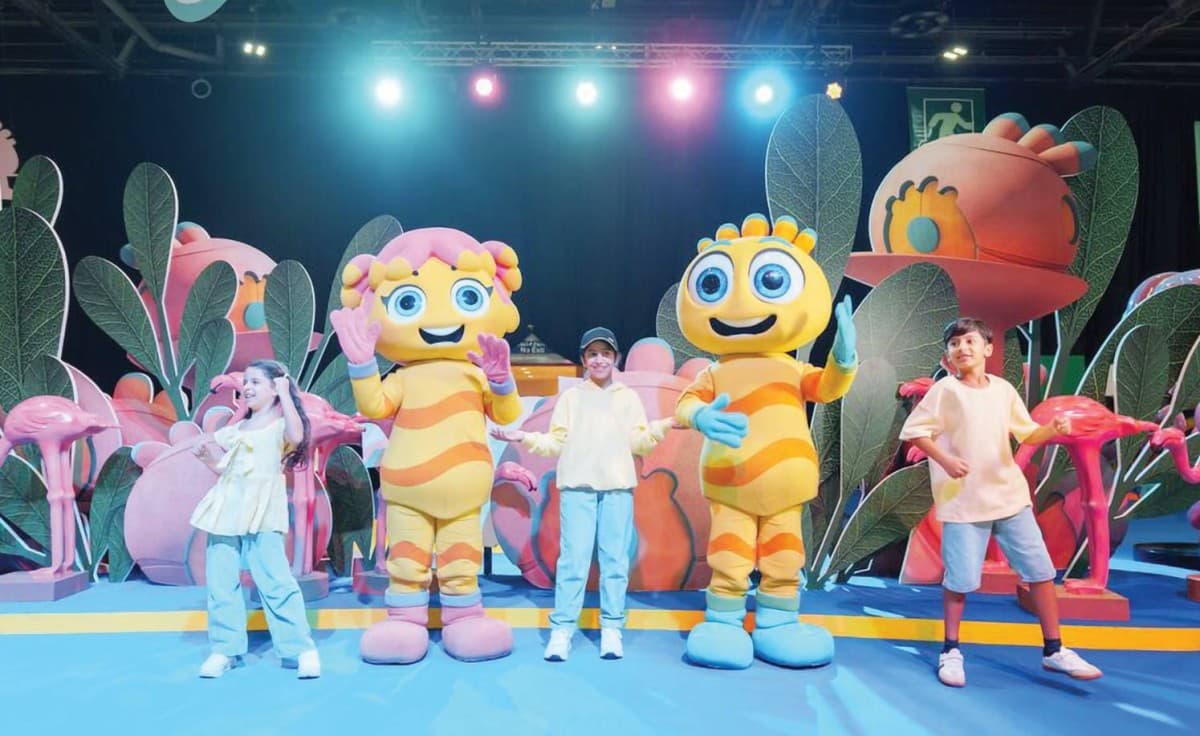 Colourful signage and characters from the 27th edition of Alam Mudhish at the Dubai World Trade Centre, featuring Baby Shark alongside Mudhish and Dana.