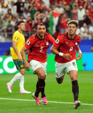 Imam Ashour celebrating after scoring a goal for the Egyptian national team at the 2026 FIFA World Cup.