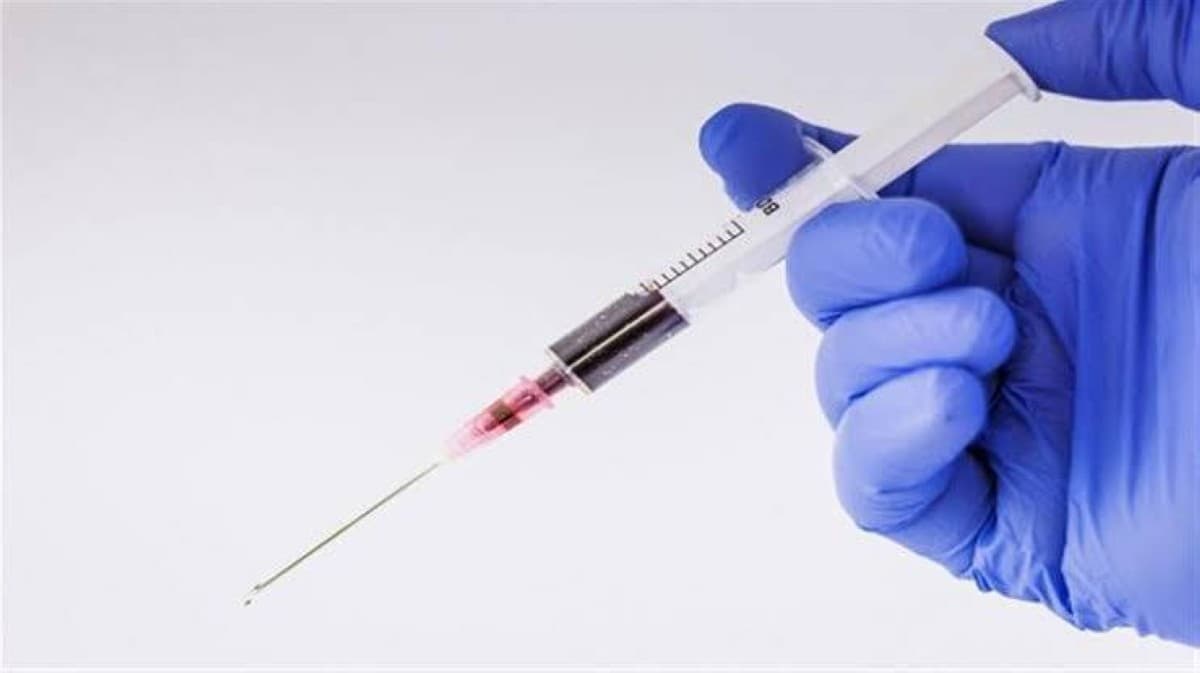 A researcher works with laboratory equipment in a study related to tuberculosis vaccine development.