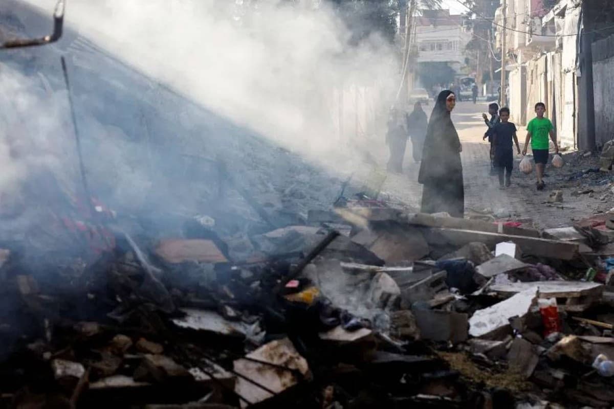 An Israeli airstrike hits a location in Gaza City, with smoke rising over buildings in the northern part of the Strip.