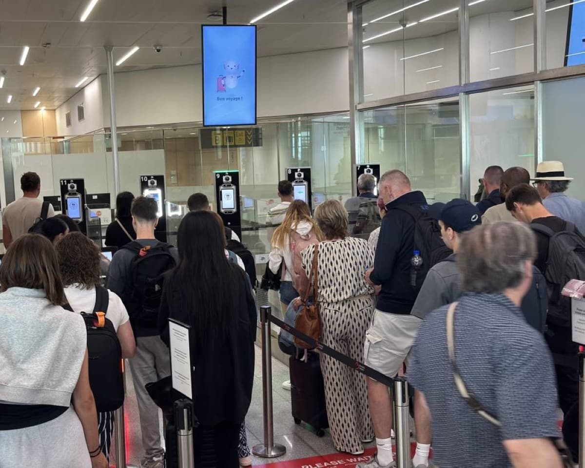 Travellers queue at a border checkpoint at a European airport as the EU's new Entry/Exit System causes significant delays.