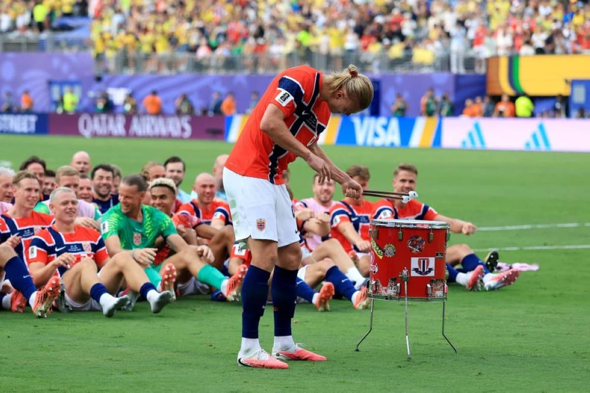 Erling Haaland beats the drums in front of Norway fans as his teammates join the Viking celebration after the team's 2-1 World Cup victory over Brazil.