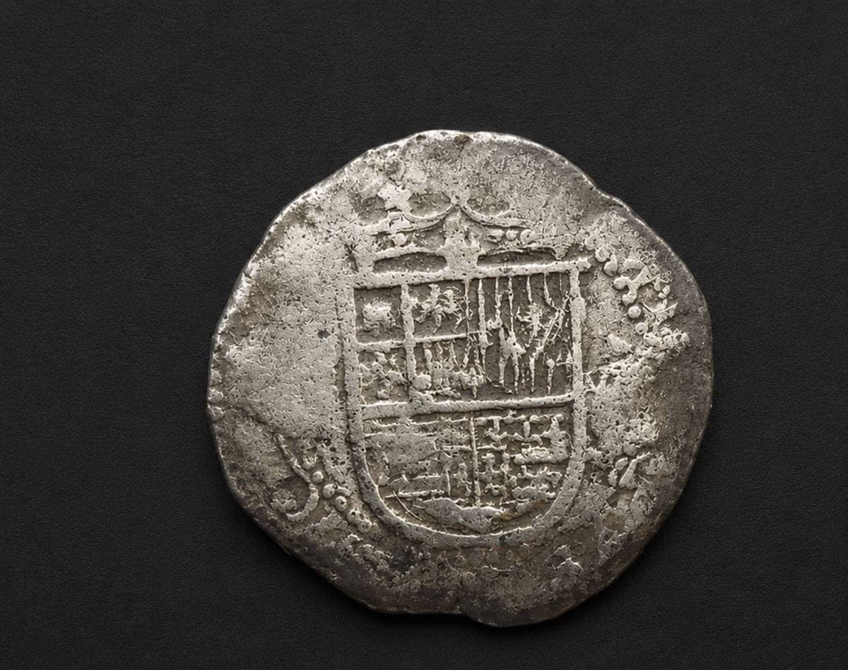 A small silver piece of eight coin recovered from beneath the foundations of a church near the Strait of Magellan in southern Chile, linked to the lost 16th-century Spanish colony known as the City of King Don Felipe.