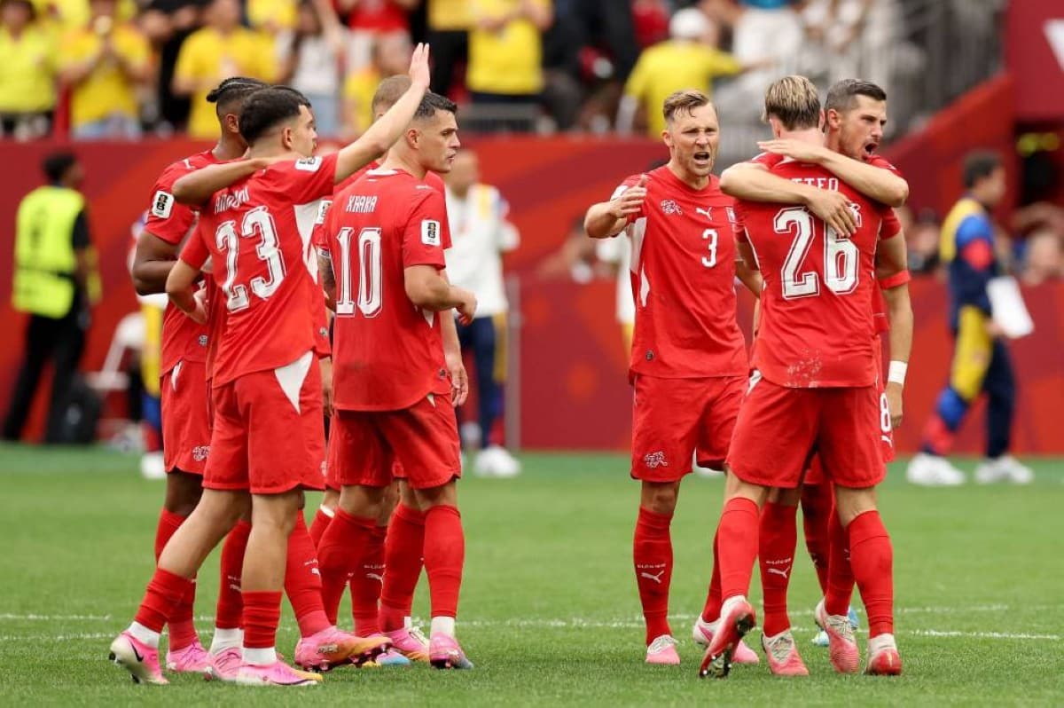 Switzerland players celebrate after winning their 2026 FIFA World Cup round-of-16 match against Colombia on penalties.