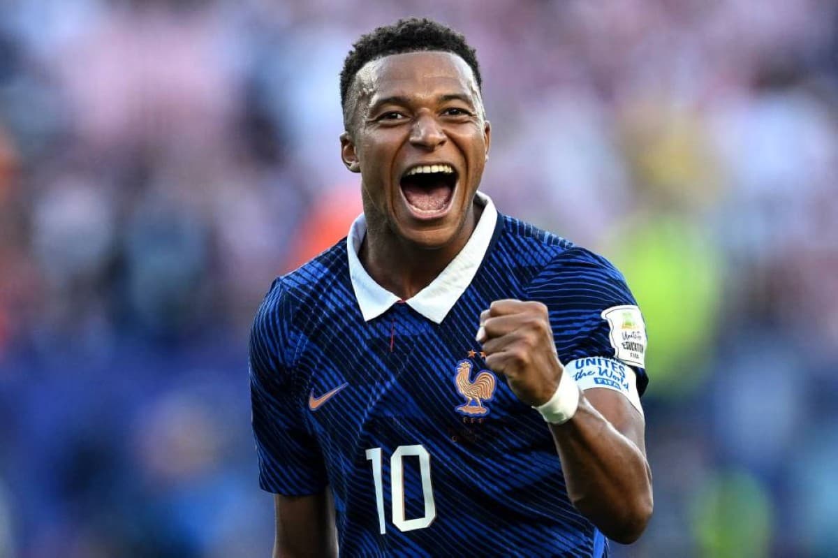 Kylian Mbappé smiles on the pitch during France's 2026 World Cup campaign.