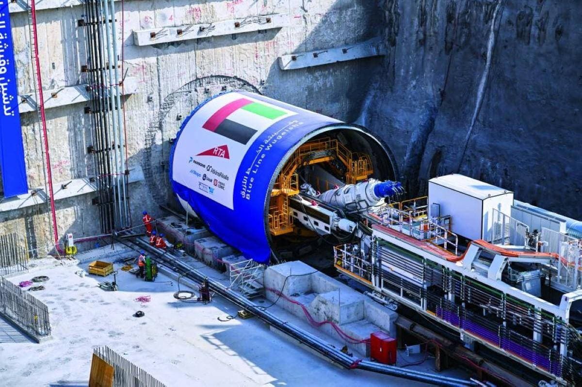 A giant tunnel boring machine underground during excavation works for the Dubai Metro Blue Line project.",