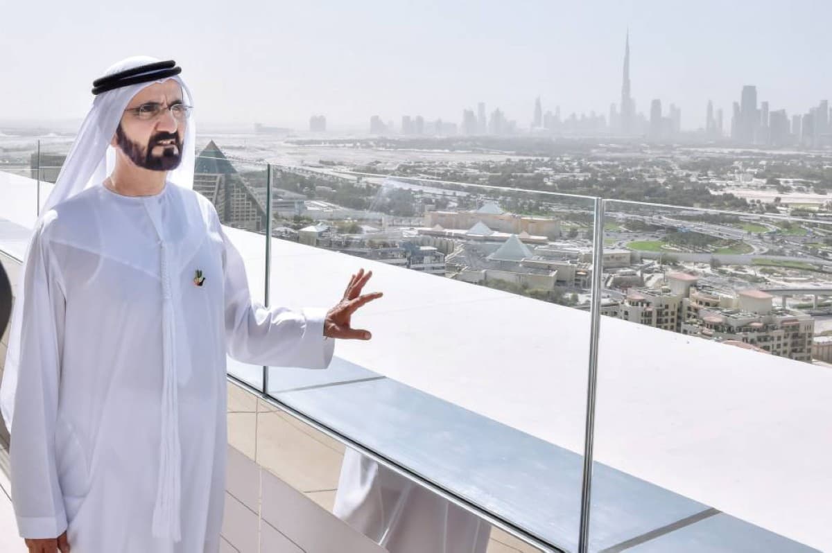 Sheikh Mohammed bin Rashid Al Maktoum speaking at a UAE investment event, with economic data and FDI figures highlighted in the background.