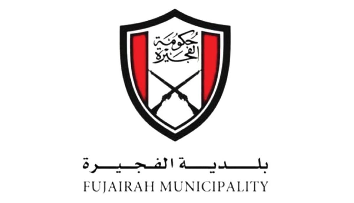 Fujairah Municipality inspectors examining seized counterfeit products during a market enforcement campaign.