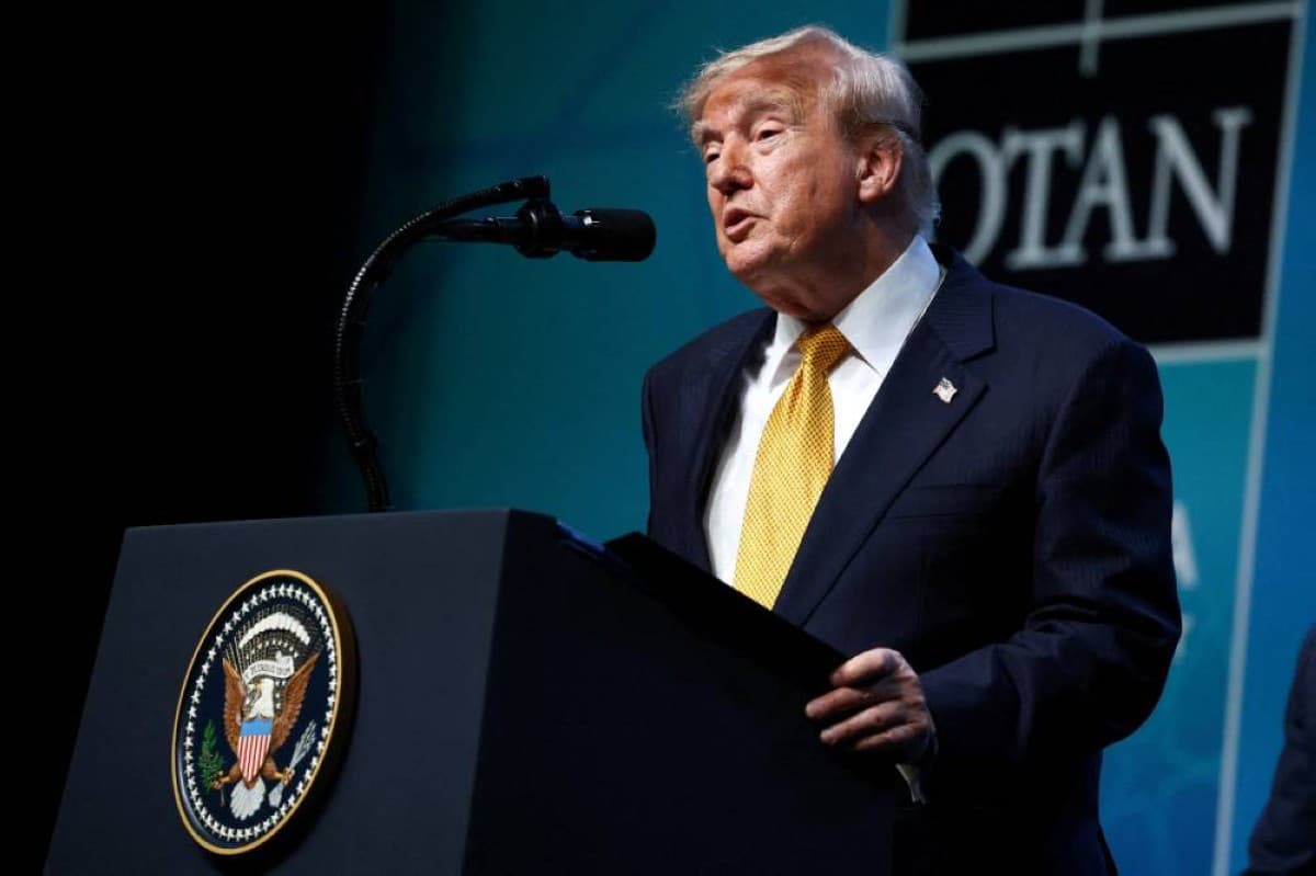 US President Donald Trump speaks at a podium during an official address.