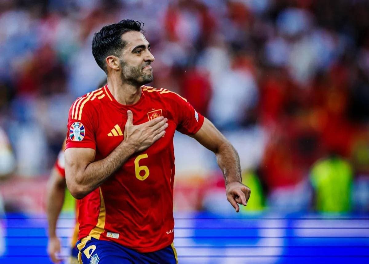 Mikel Merino celebrates after scoring a late winning goal for Spain during a 2026 World Cup knockout-stage match.