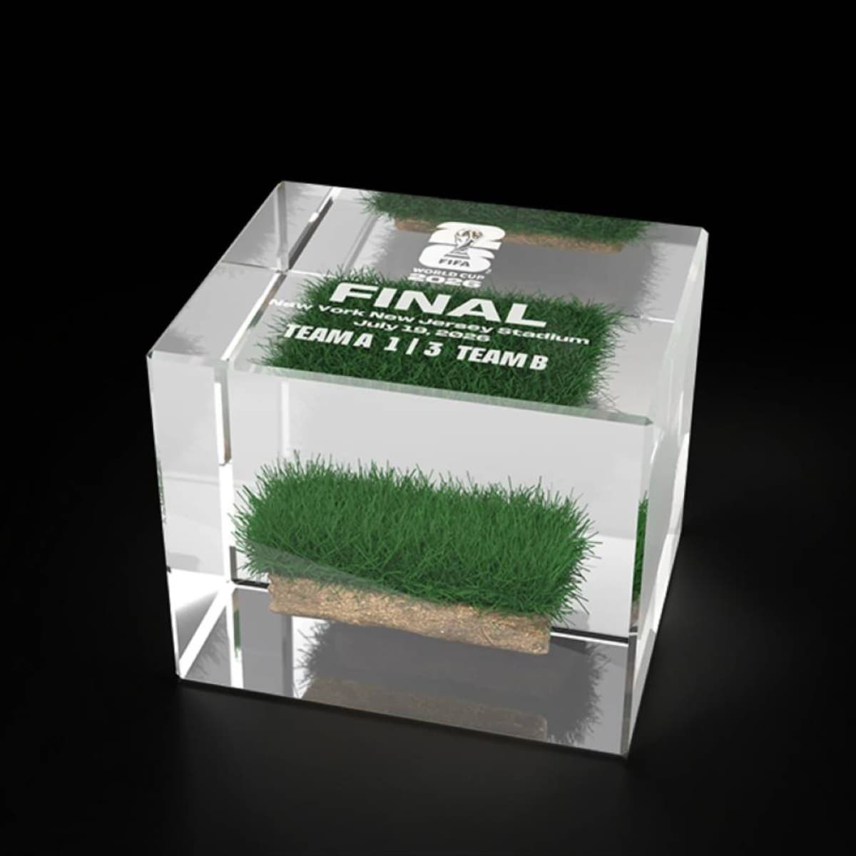 A packaged section of pitch grass from the 2026 World Cup final at MetLife Stadium, presented in a luxury acrylic display case as a collectible item.
