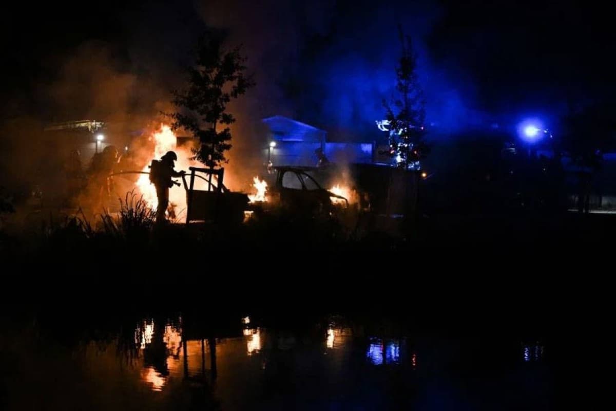 Firefighters battling a wildfire burning through forest land in southern France.